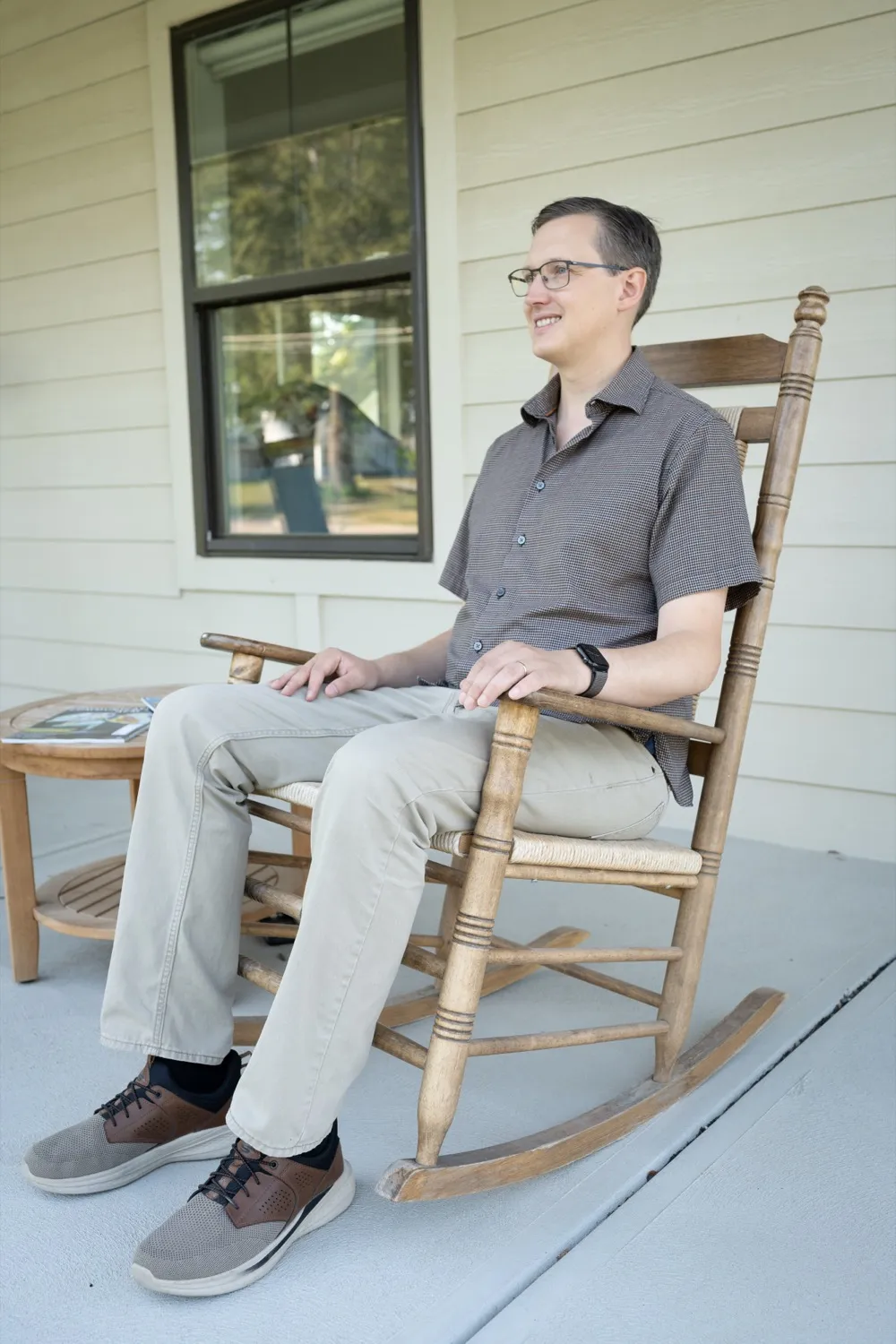 Georg Link in a rocking chair on his front porch