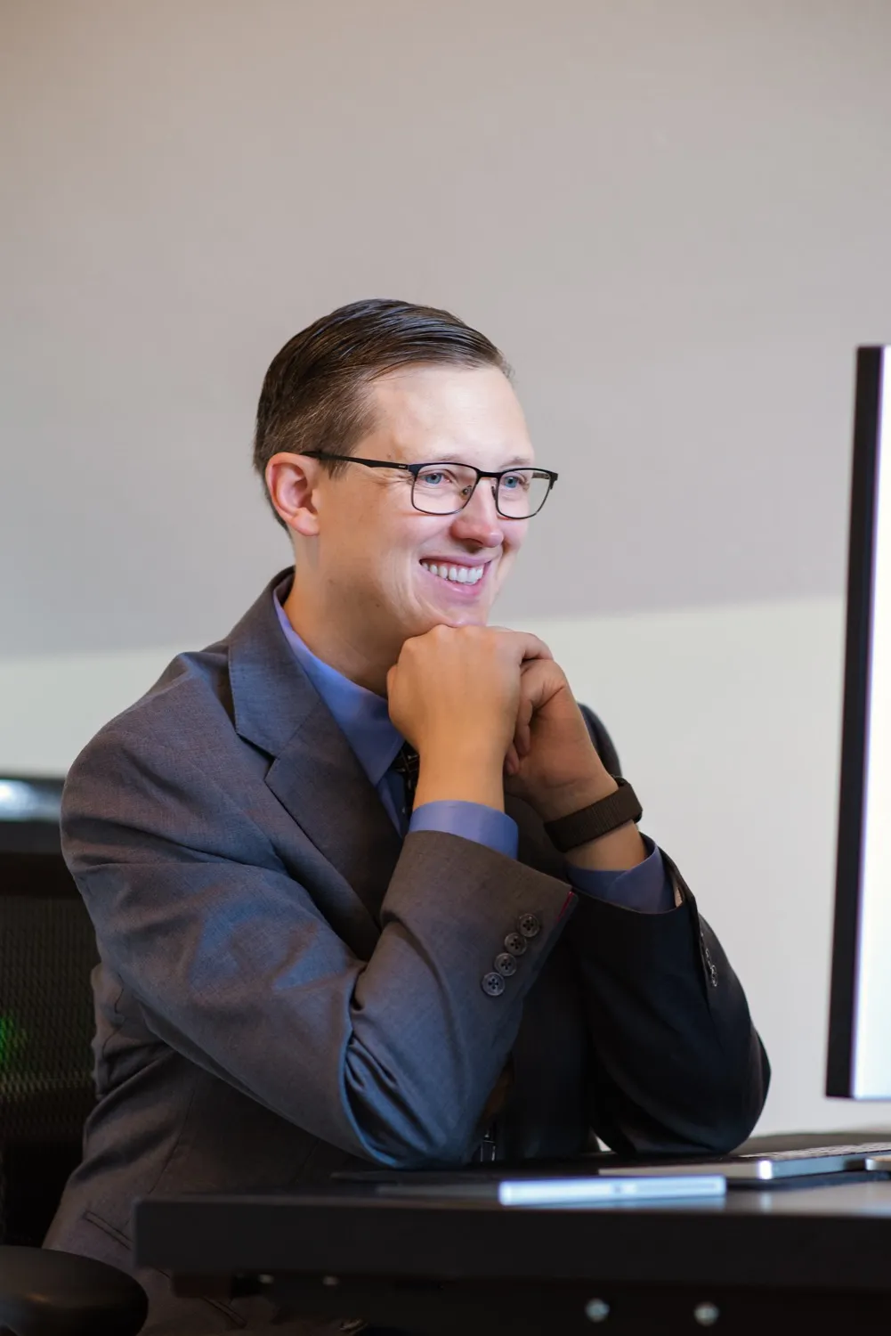 Georg Link in a suit at his desk, smiling